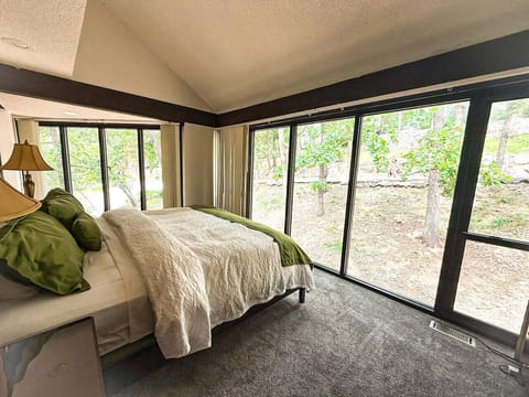 Wake up surrounded by treetops—this bedroom offers serene views and forest calm.