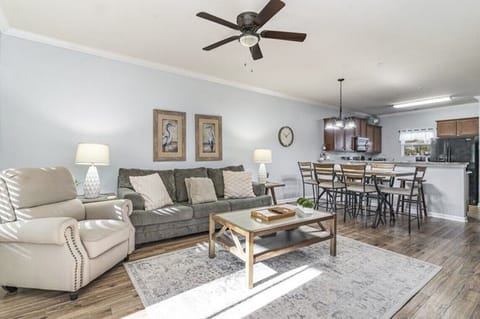 Open concept living room with cozy seating and a modern touch.