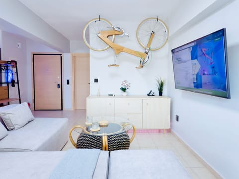 Living room with Smart TV and a handmade wooden bicycle as artwork.