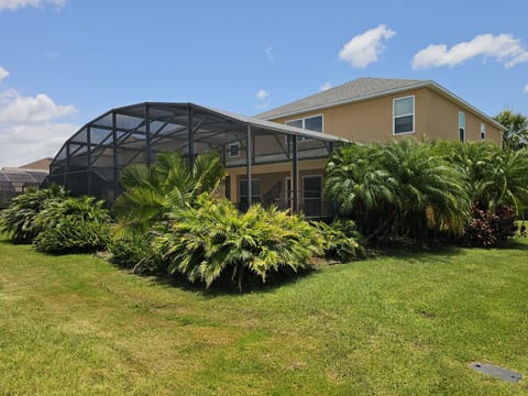 Rear view of house with landscaping