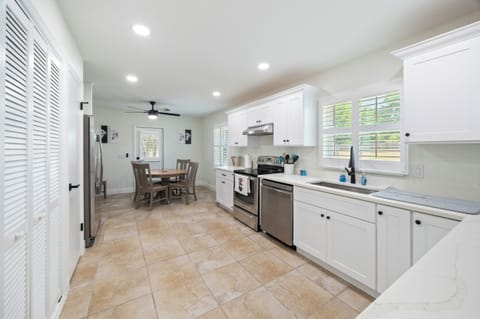 kitchen with view to dining table and patio entrance