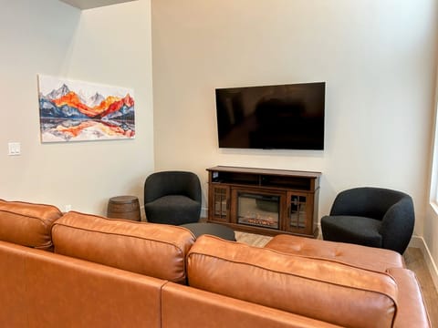 modern living room offers comfy seating, cozy fireplace, and a SmartTV