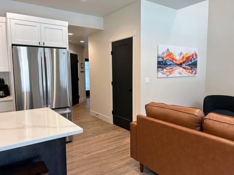 modern living room offers comfy seating, cozy fireplace, and a SmartTV