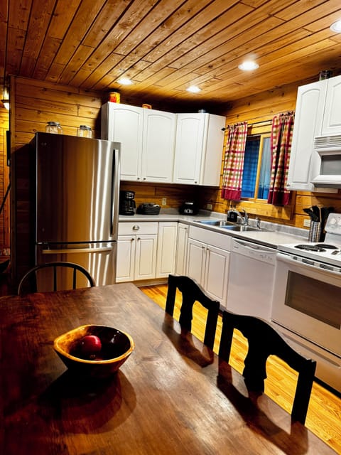 Full kitchen with full set of dishes, pans, and kitchen utensils.