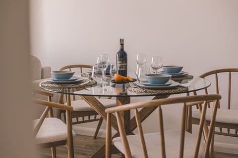 Modern glass dining table – perfect for a seaside apartment breakfast experience