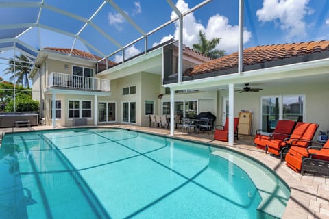 Your private pool paradise awaits with crystal-clear water, vibrant loungers, and a screened lanai for shade.