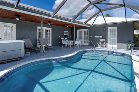 Dive into your private oasis! This stunning enclosed pool area offers year-round swimming comfort with stylish patio seating and a relaxing hot tub just steps away.