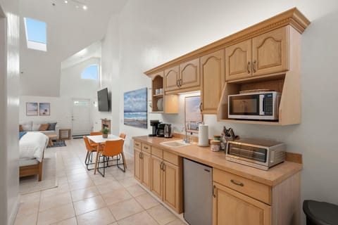 Well-equipped kitchen with coffee maker, microwave, toaster, and mini fridge