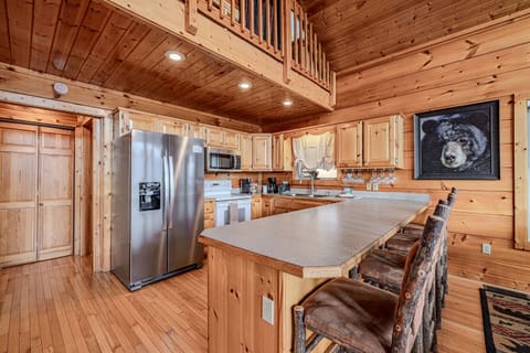 Cook, gather, and enjoy! This kitchen features the rustic warmth of natural wood cabinetry and floors, perfectly balanced with modern stainless steel appliances.