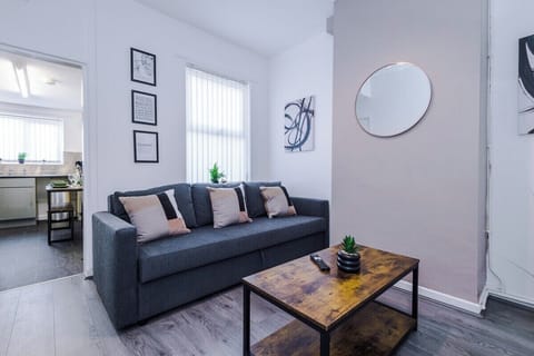 Relax in the bright and inviting living room, complete with a cozy sofa and stylish décor.