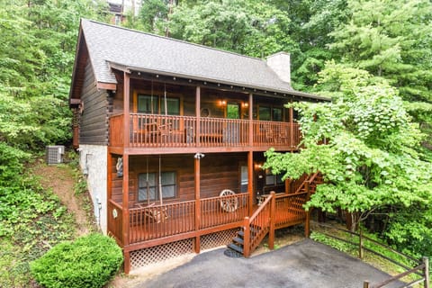 Classic log cabin charm with double porches, a private driveway.