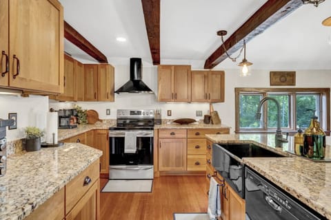 Large, open kitchen with granite countertops and all the essentials to cook for the whole family