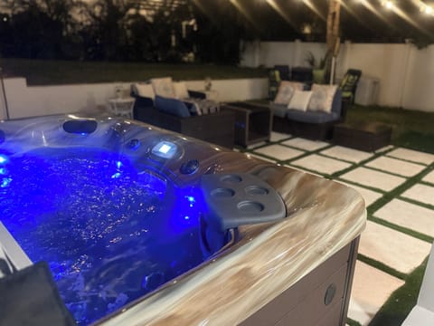 6-person hot tub with waterfalls, LED lights and cup holders