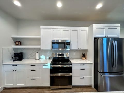 fully stocked spacious kitchen island with four inviting bar seats