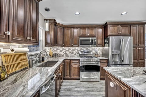 Recently remodeled, the kitchen features granite countertops, stainless steel appliances, modern cabinetry, and an open layout. Enjoy Austin-inspired decor while making your favorite meals in this fully-stocked kitchen.