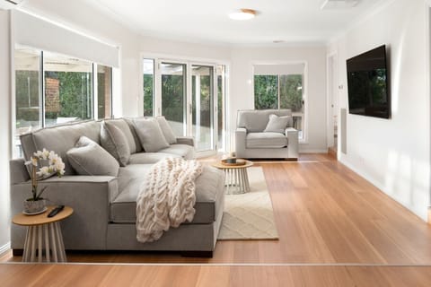 Living Room: Bright and airy retreat with plush seating & smart TV.