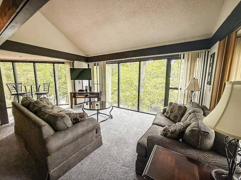 `Soak in the stunning tree lined views from our bright and comfortable living room, a perfect spot to relax and unwind at the Lake of the Ozarks.`