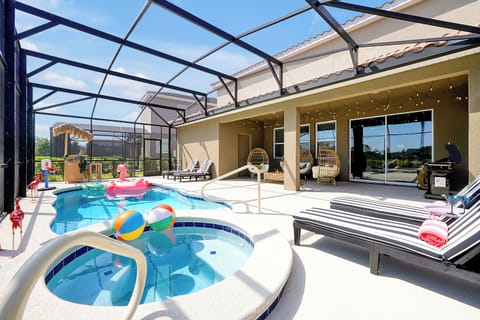 Pool with inflatables, sunloungers, in a glass enclosure