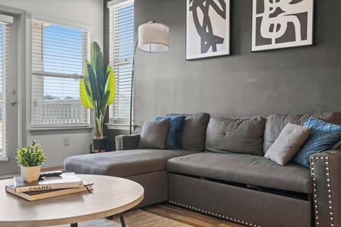 With cozy seating and soft lighting, this living room is the perfect place to wind down, read a book, or watch TV.