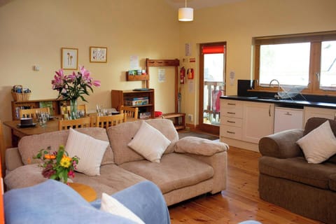Two two seater sofas. Coffee table with a vase of flowers