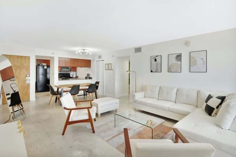 Pristine living room enriched with an abundance of natural light from floor to ceiling window!