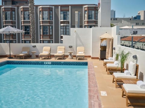 Dive into sunshine and lounge poolside with city views.