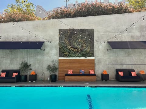 Gather with friends by the poolside cabanas and vibrant cushions.