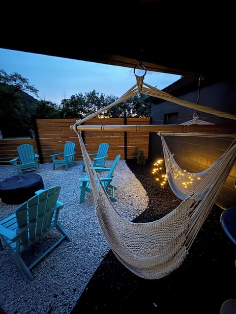 Private fenced in Outdoor gas fire pit, hammock swings and gas grill with patio dining.