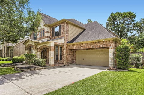 Exterior View: Elegant brick facade with lush greenery, perfect for your Texas getaway!