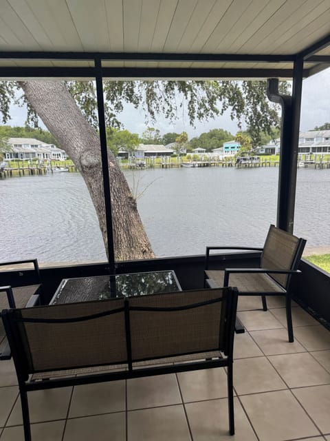 Large enclosed patio which leads to the pool with seating.