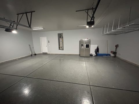 Garage with fridge and cleaning supplies