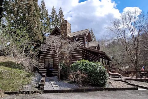 Experience rustic charm in this log cabin with inviting porches and nature views!