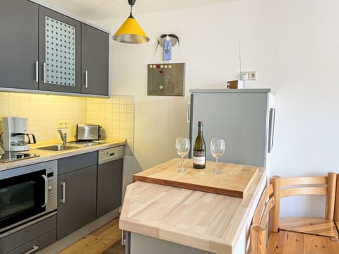 Furniture, Kitchen, Kitchen Appliance, Countertop, Major Appliance, Flooring, Interior Design, Cabinetry, Wood, Floor