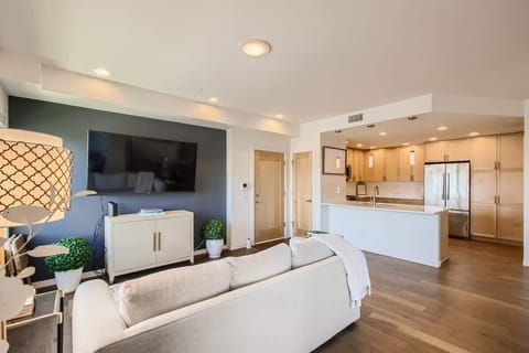 Elegant open-concept layout featuring a welcoming living room, fully equipped kitchen, and stylish dining space for family and friends.