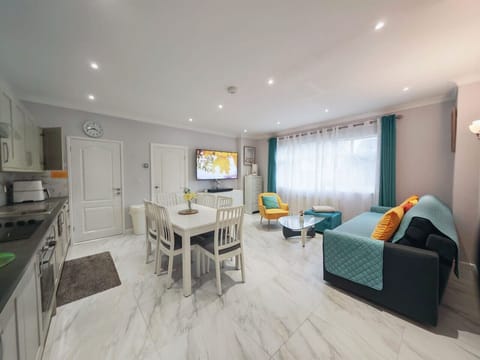 Spacious open-plan room combining kitchen, dining and lounge areas.