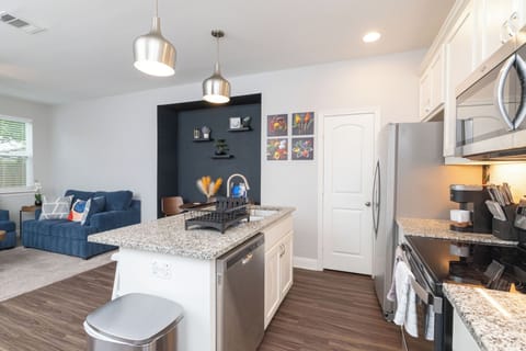 Fully stocked kitchen, island seating for 2 and stainless steel appliances.