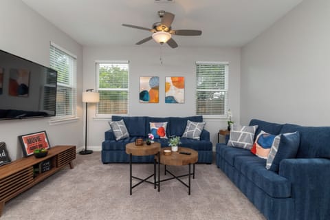 Comfy living room with 2 couches and flat screen TV.