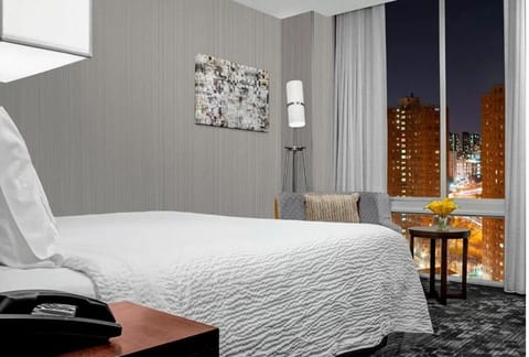 Unwind by the window with dazzling city lights below.