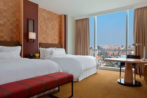 Wake up to skyline views from crisp twin beds.