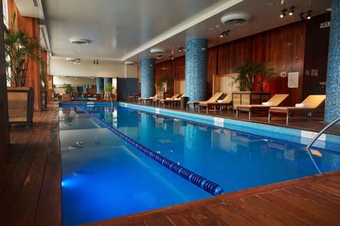 Swim calm laps in a bright, resort-style indoor pool.