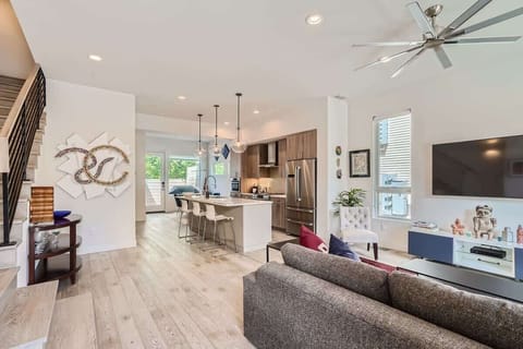A seamless living space combining the living room, modern kitchen, and kitchen table, creating a natural flow for cooking, dining, and relaxing.
