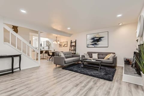 Relax in a warm, inviting living room with neutral tones and comfortable seating—perfect for unwinding after a long day.
