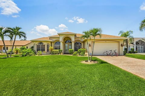 Charming villa with lush landscaping and ample driveway space, perfect for family getaways.