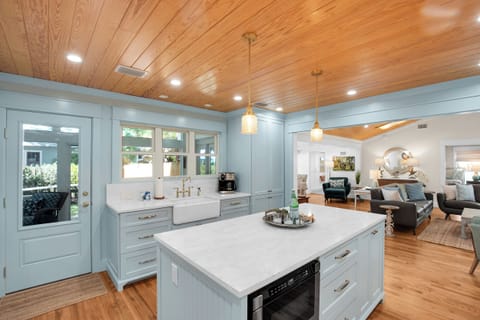 The kitchen has an open concept with access to the screened-in porch
