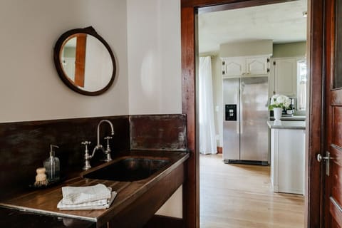Modern design meets convenience in this stylish bathroom, which offers a view of the kitchen area
