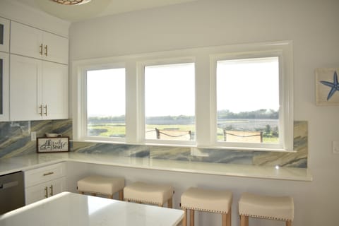 Bar seating overlooks the sound -- enjoy a peaceful coastal backdrop while dining or sipping drinks.