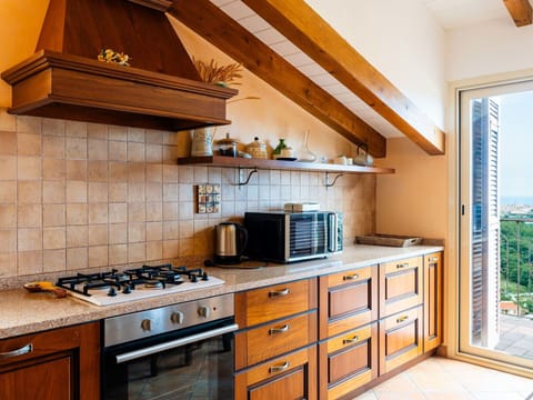 Kitchen, Countertop, Kitchen Appliance, Major Appliance, Interior Design, Cabinetry, Kitchen Stove, Flooring, Wood, Stove