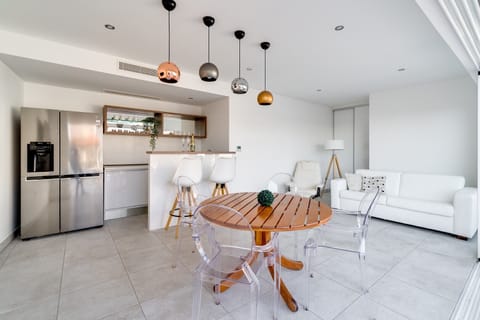 Modern summer kitchen and lounge area next to the pool