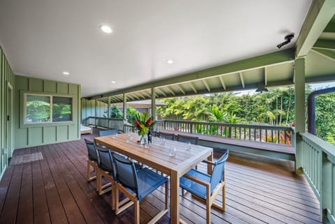 Gather for alfresco meals on the covered lanai, surrounded by tropical greenery and gentle breezes.