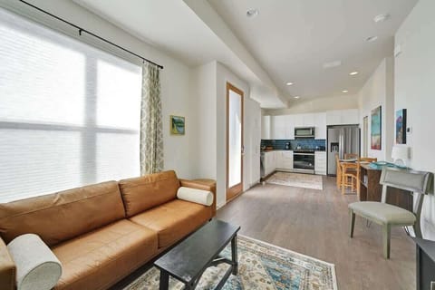 Bright open home layout connecting entry, kitchen, dining, and living spaces